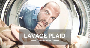 Une personne devant sa machine à laver qui se demande comment laver un plaid